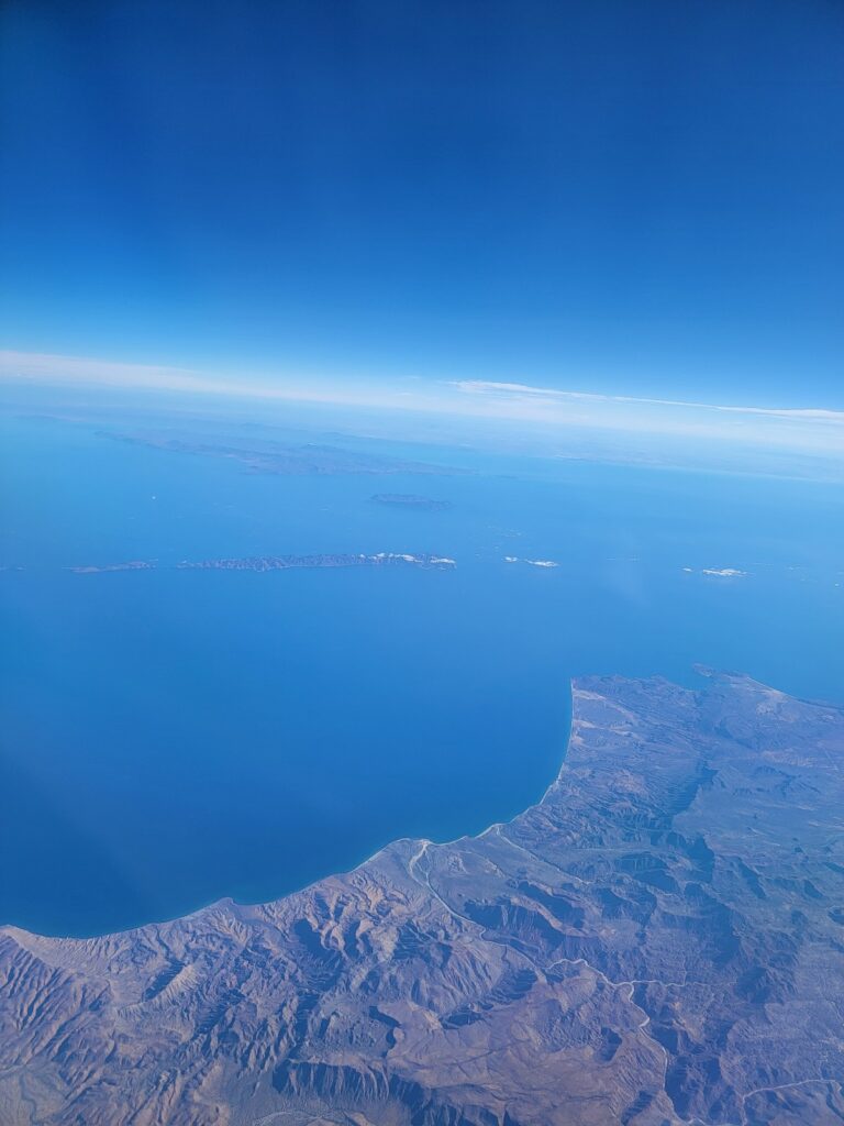 a view of a city and the ocean from a plane