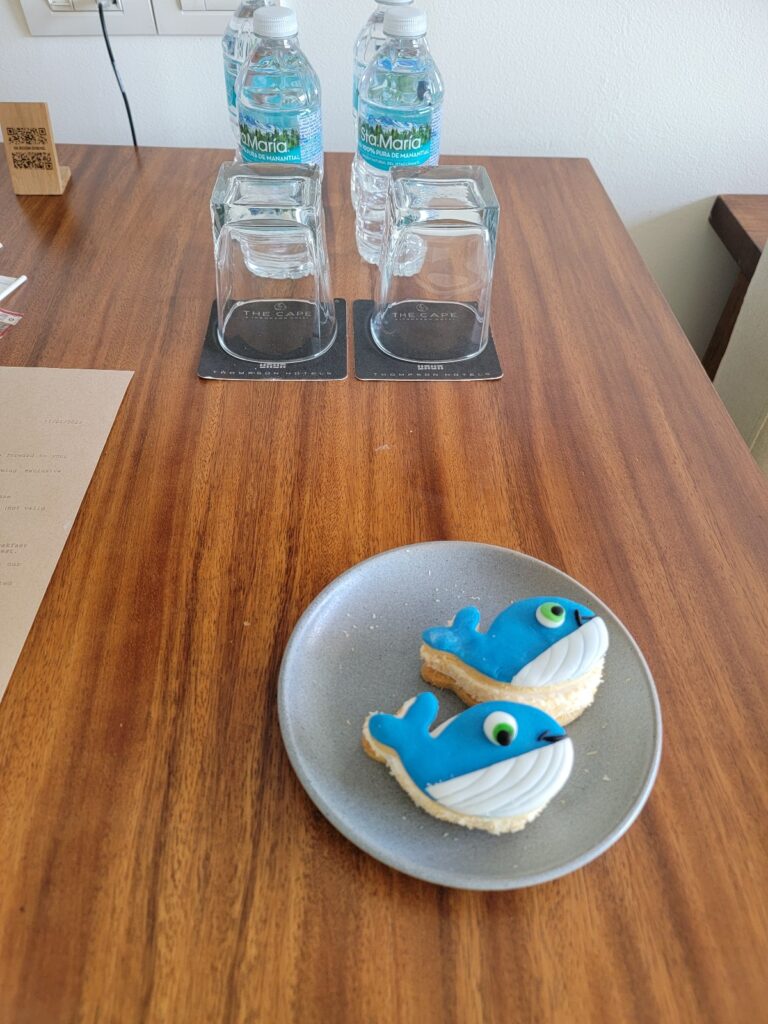 a plate with a blue bird on it and a couple of water bottles on the side