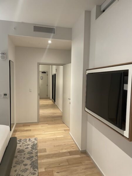 a hallway with a tv and a couch