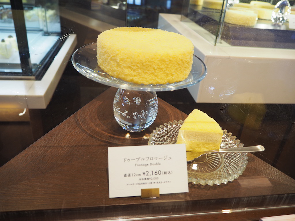 a glass bowl with a yellow dessert in it