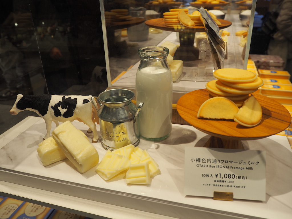 a display of cheeses and other food items