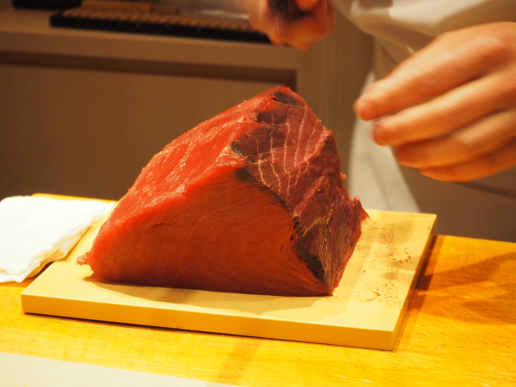 a person cutting a piece of meat