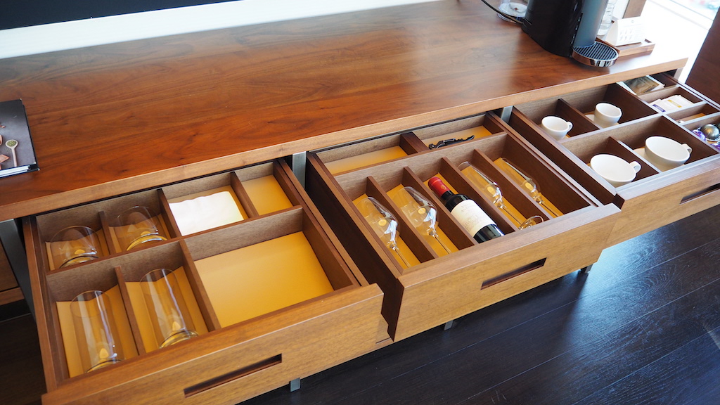 a wooden cabinet with bottles of alcohol