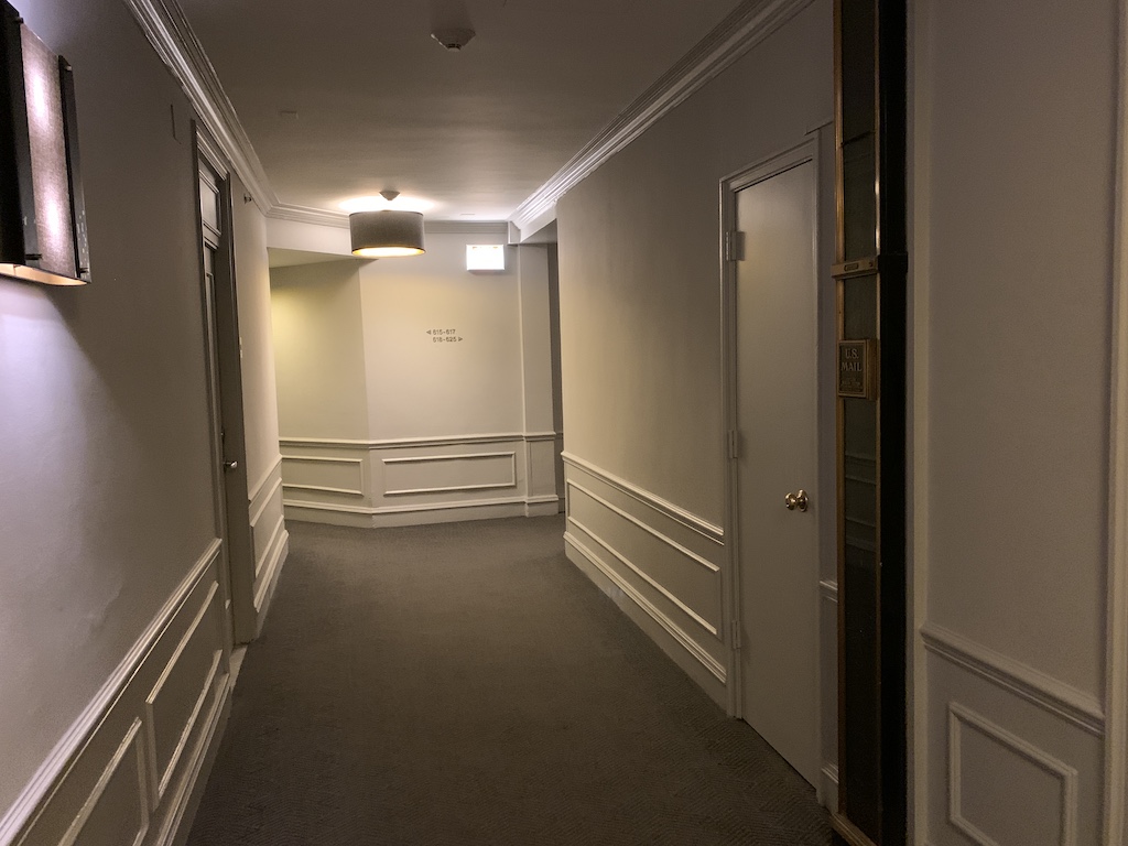 a hallway with white doors