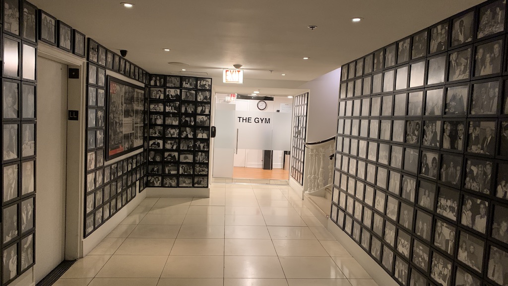 a hallway with a wall of pictures