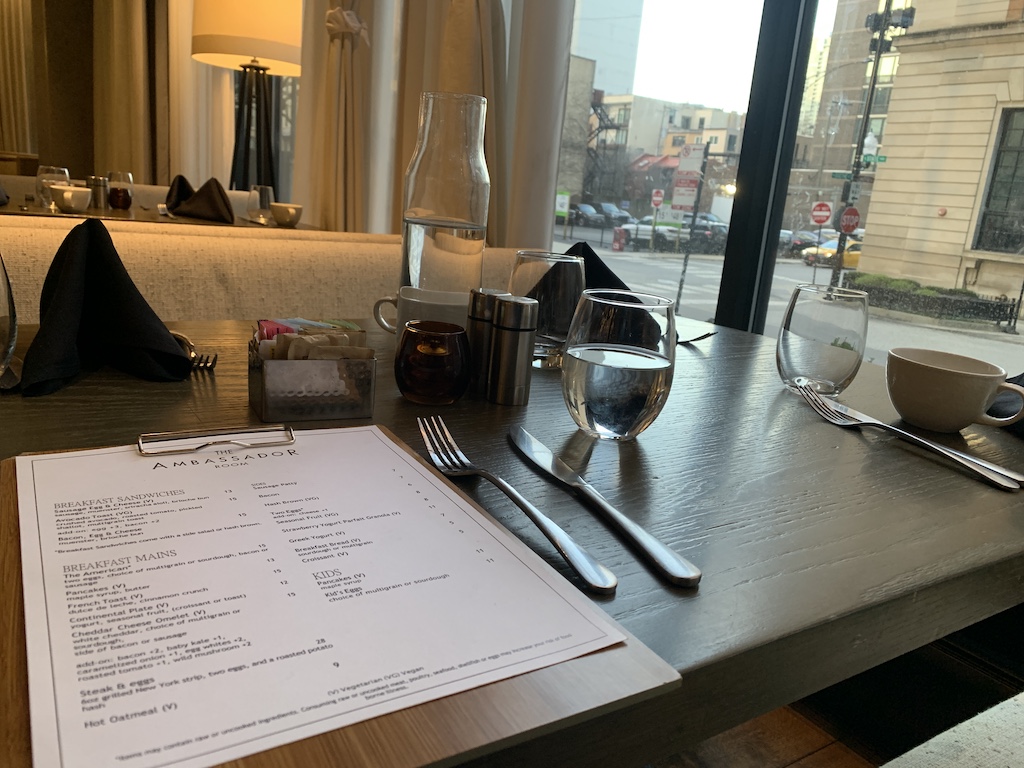 a table with a menu and glasses