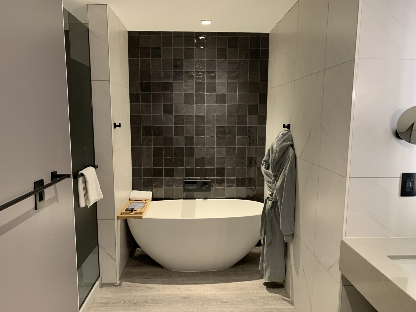 a bathroom with a tub and a shower unit