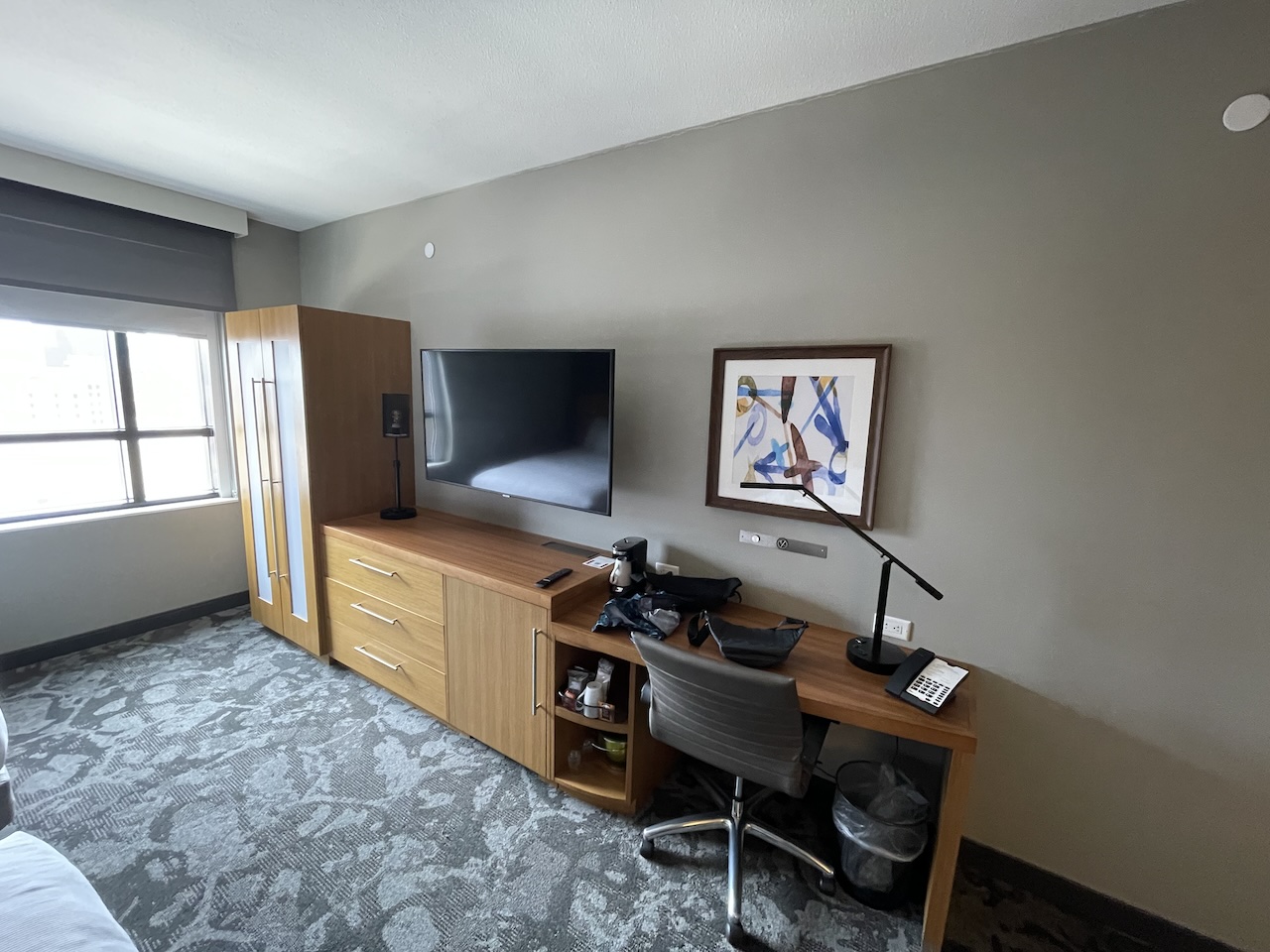 a room with a desk and a tv