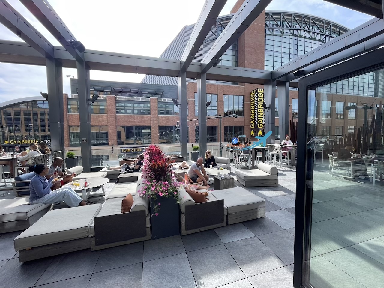 a group of people sitting on a bench in a large building