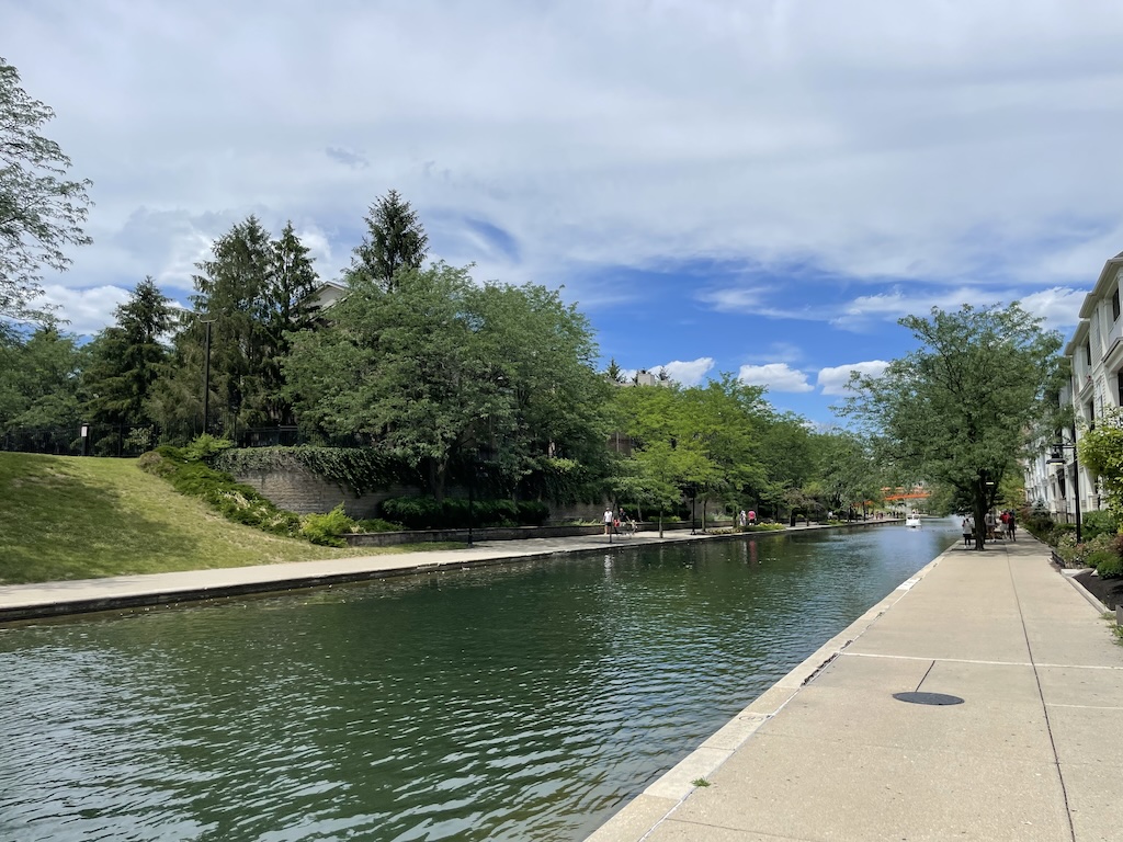 a body of water with trees and buildings around it