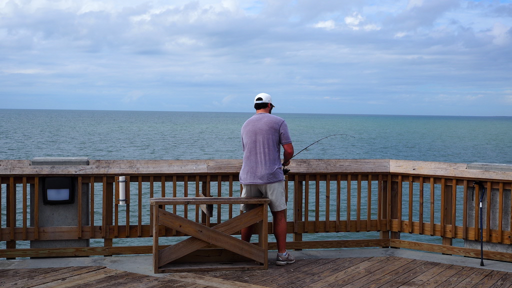 a man fishing on a pier