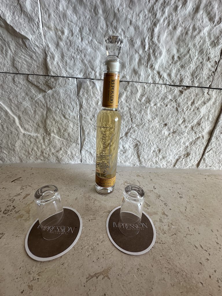 a bottle of alcohol and glasses on a table