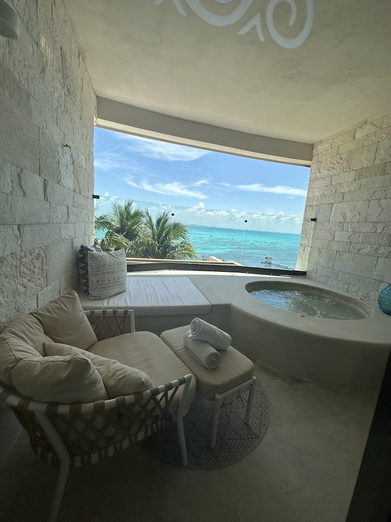 a bathtub and a chair in a room with a window