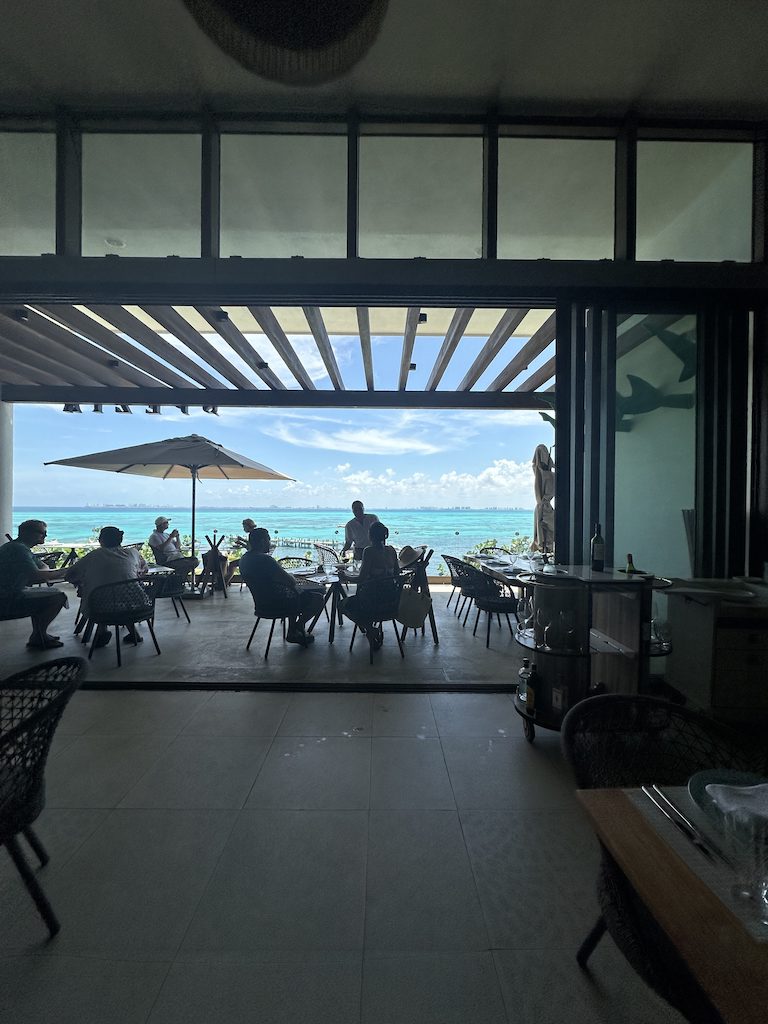 a group of people sitting at tables in a restaurant