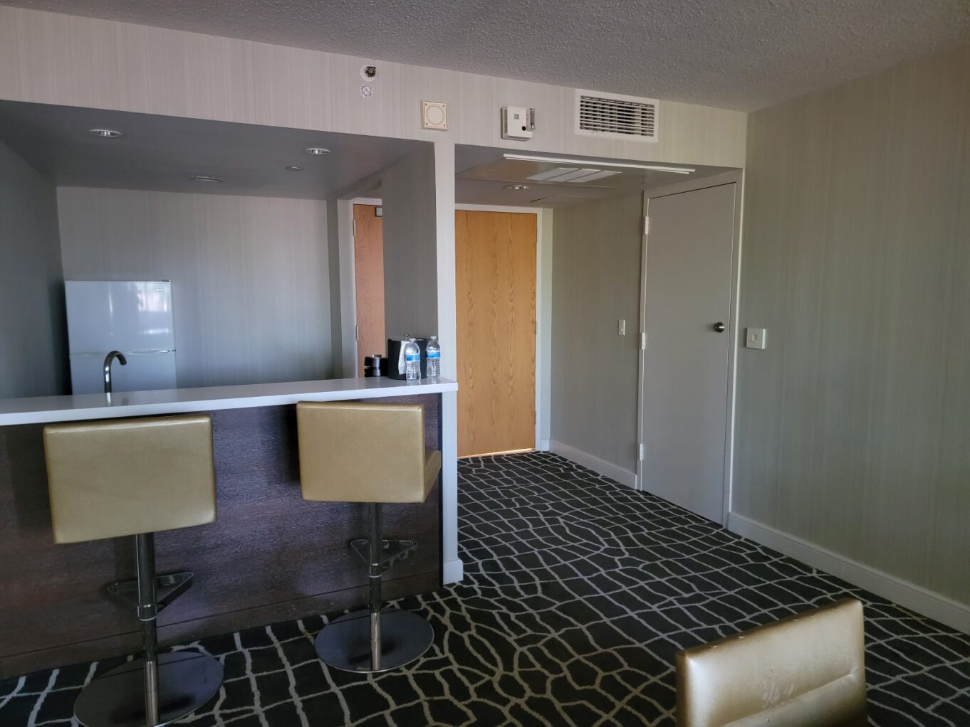 a bathroom with a bar and stool