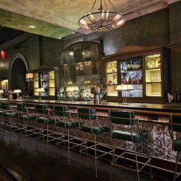 a bar with green chairs