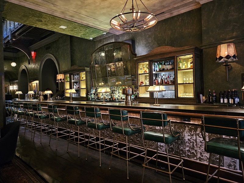 a bar with green chairs