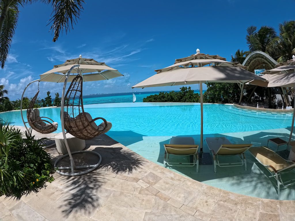 a pool with umbrellas and chairs by it