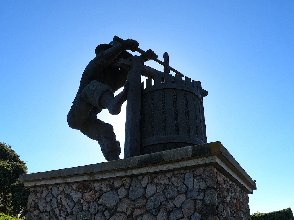 a statue of a person holding a cross