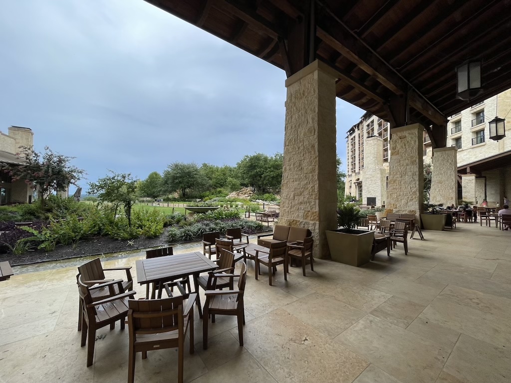 a patio with tables and chairs