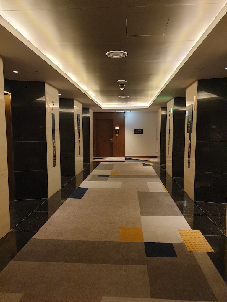 a hallway with black and white tiles