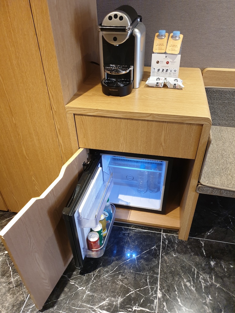 a small wooden box with a coffee maker on top