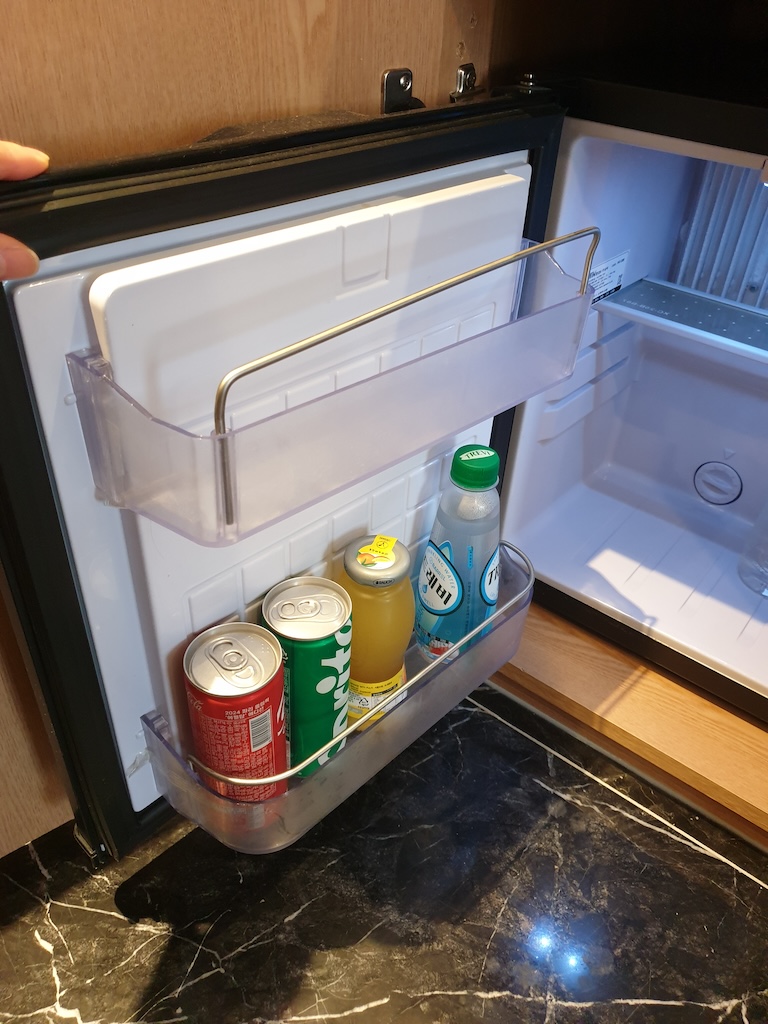 a refrigerator with a couple of beverages in it