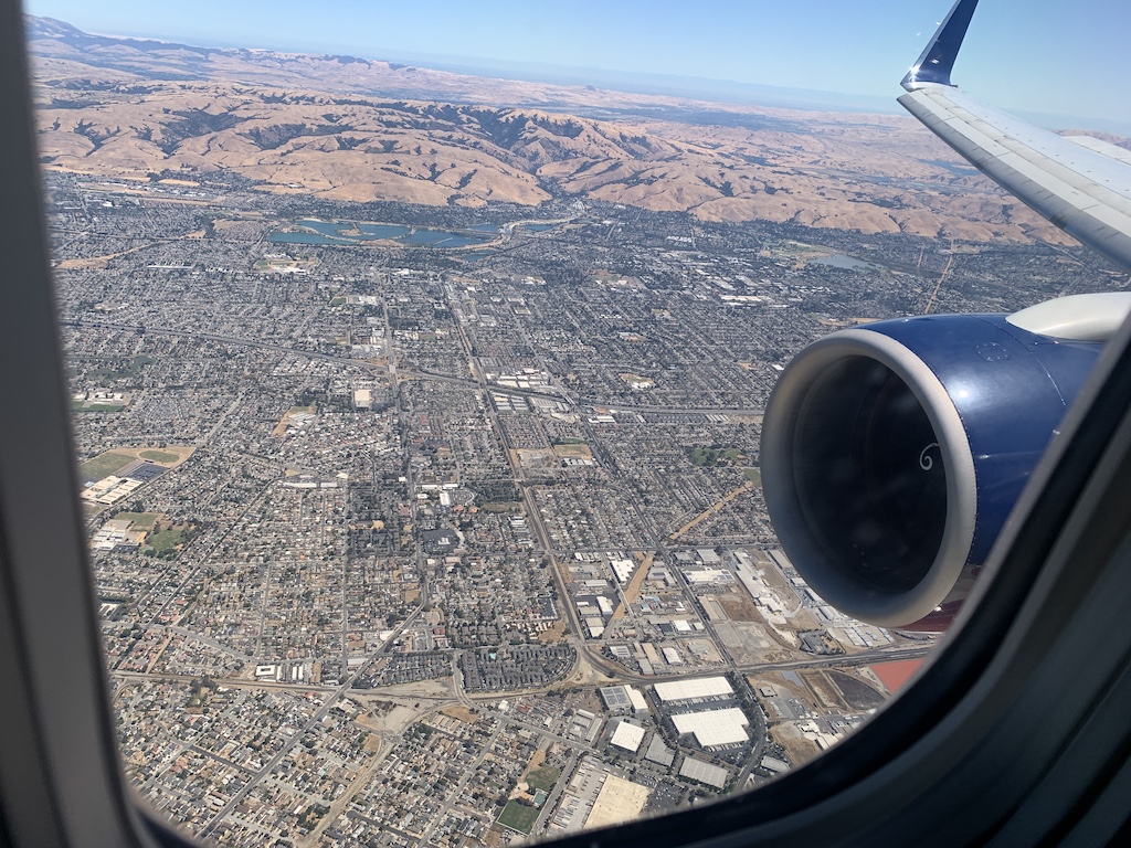 an airplane wing with a city below