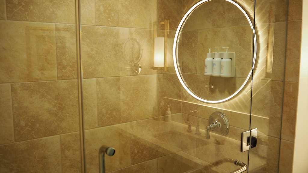 a bathroom with a round mirror