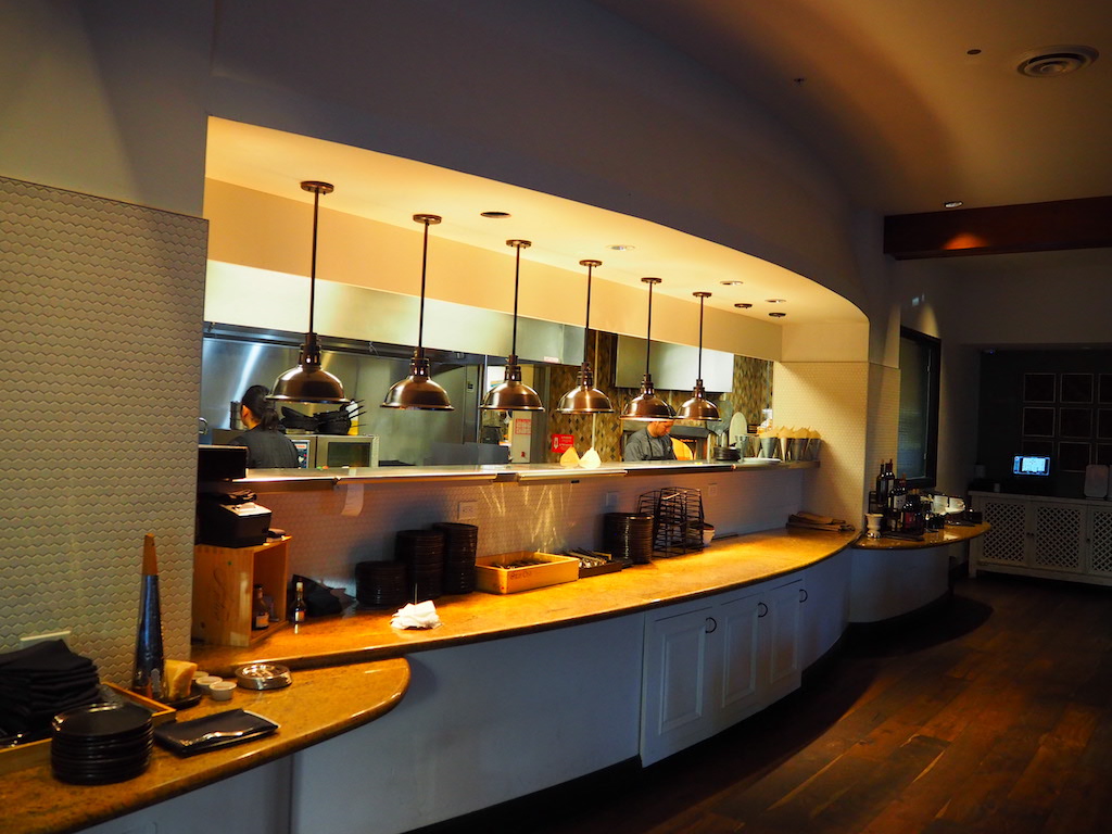 a kitchen with a large chandelier over the counter