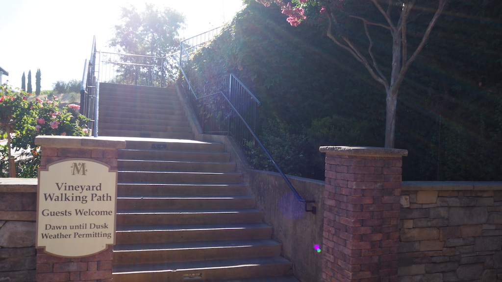 a set of stairs leading up to a stone wall