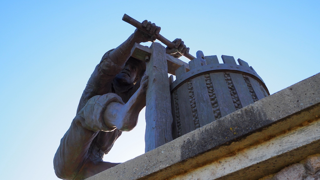 a statue of a person holding a cross