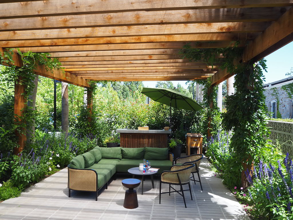 a patio with a couch and a table and chairs