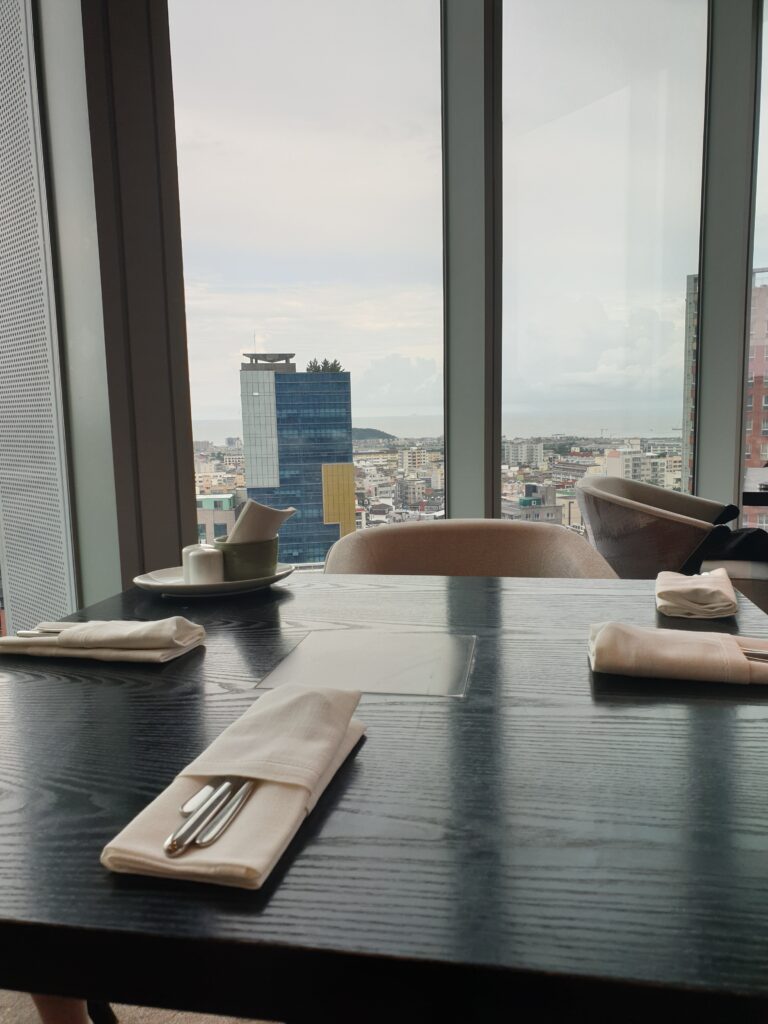 a table with a fork and napkins on it by a window