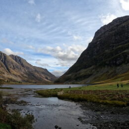 a river running through a valley between mountains