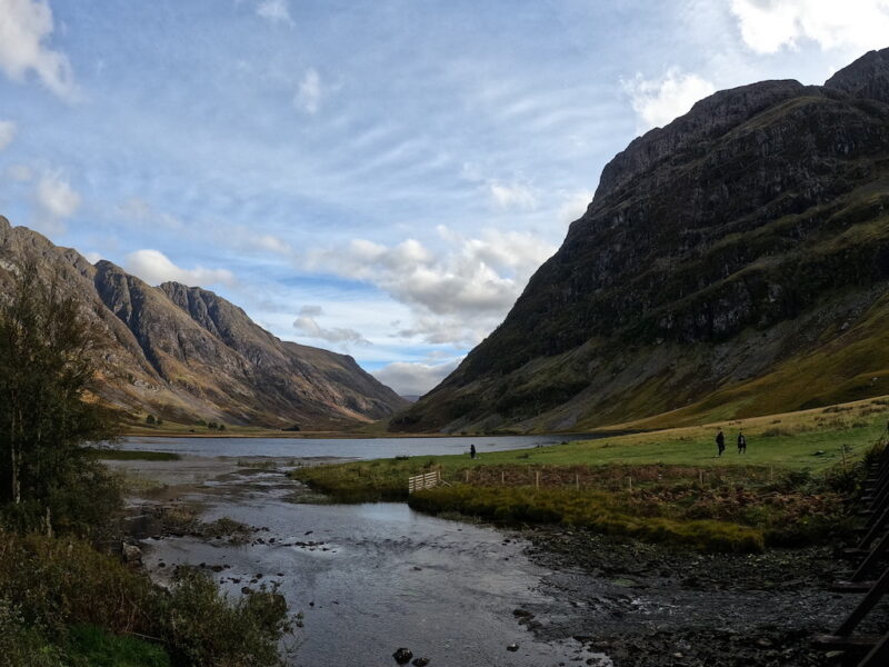 a river running through a valley between mountains