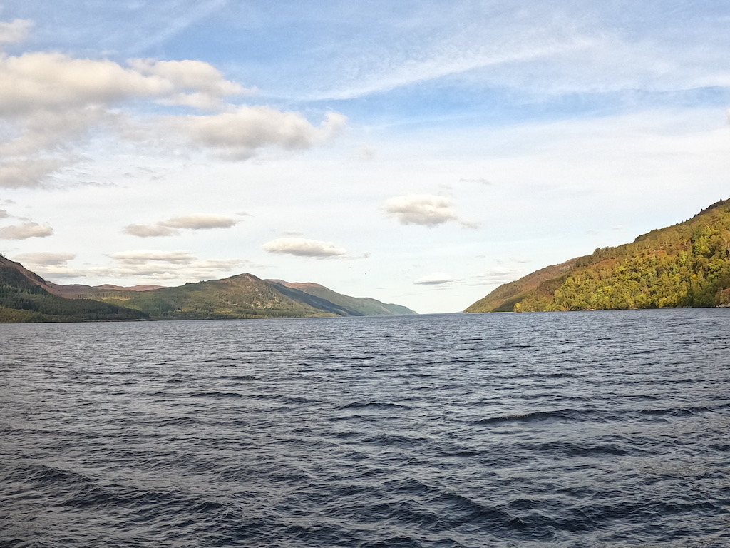 a body of water with hills in the background