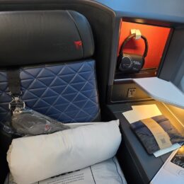 a seat with a blue cover and a blue pillow