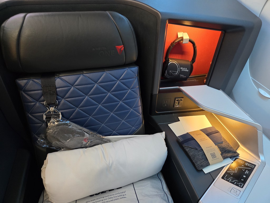 a seat with a blue cover and a blue pillow