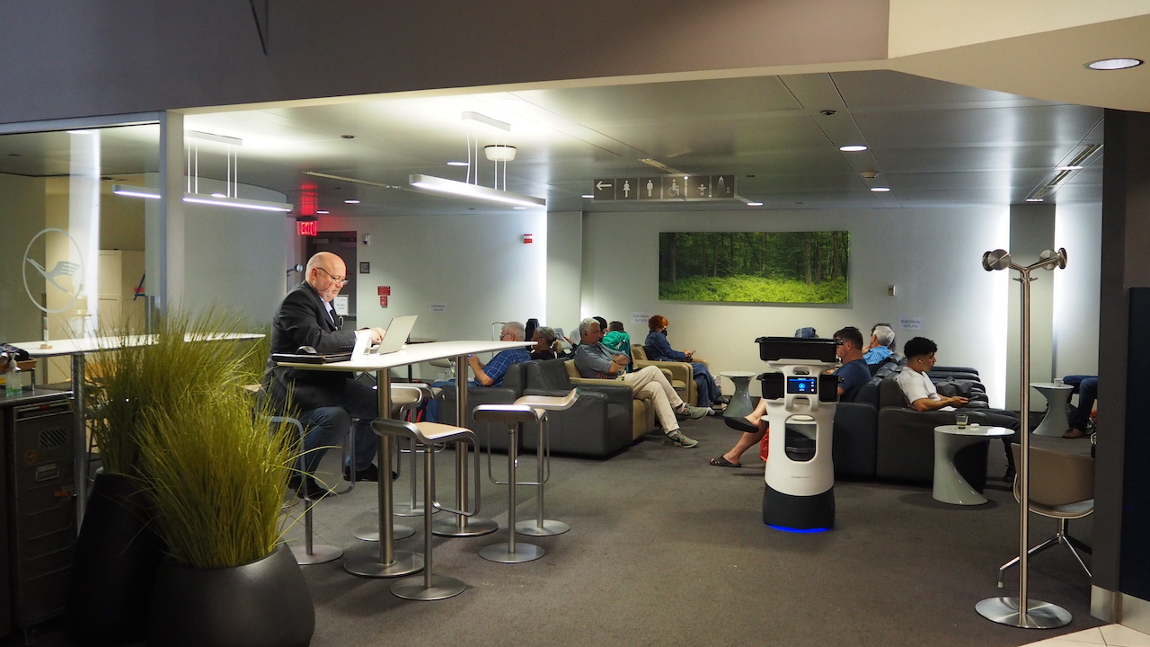 a group of people sitting in a room with laptops