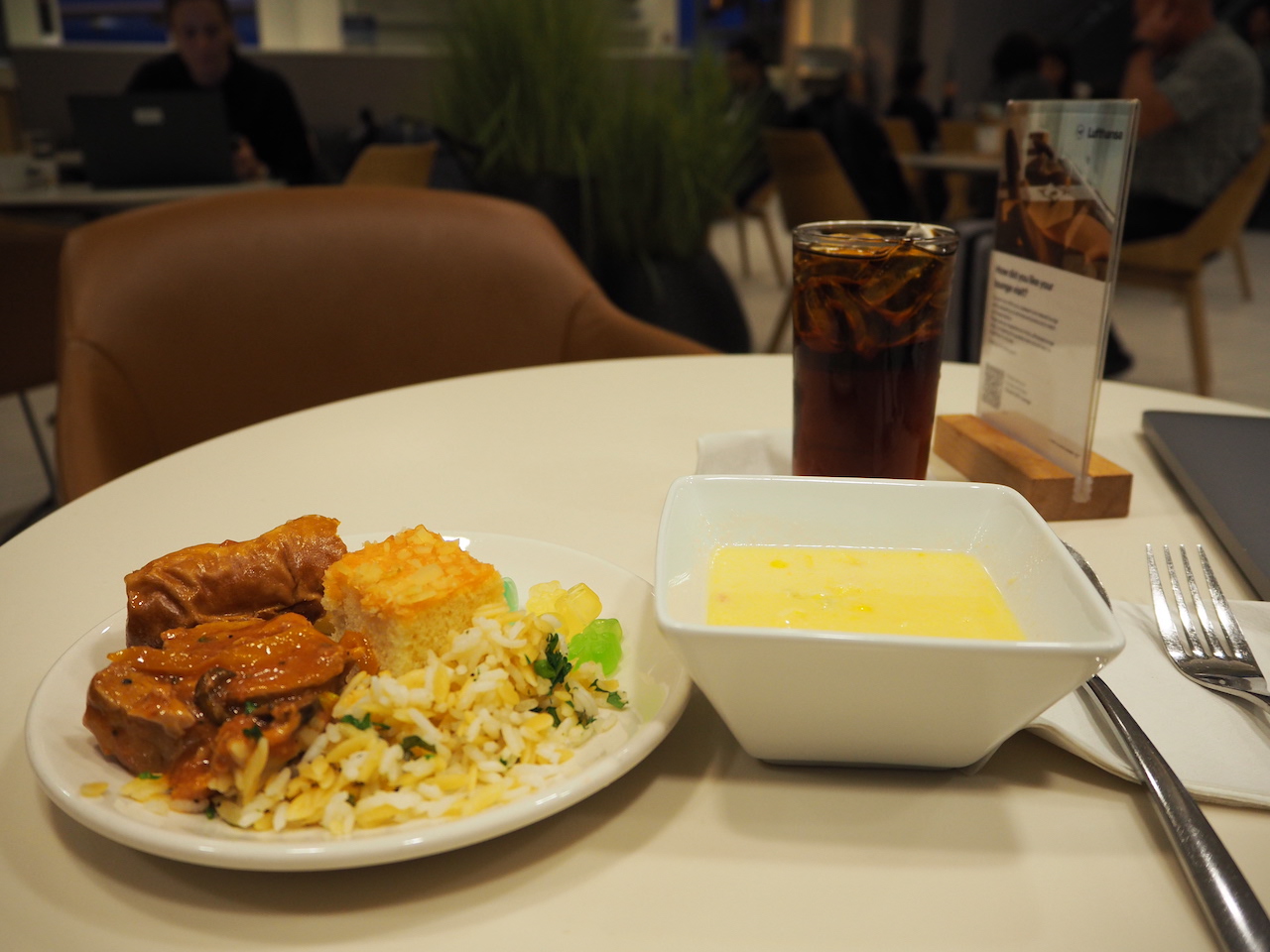 a plate of food and a glass of beer on a table