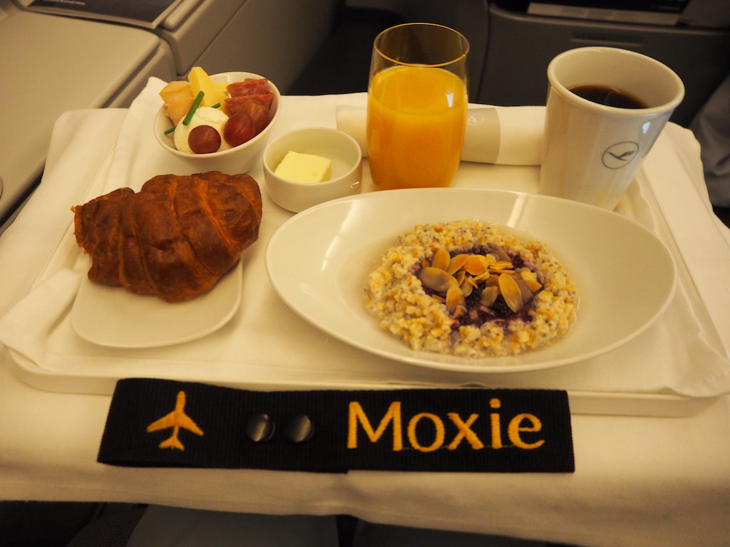 a tray with plates of food and cups of coffee