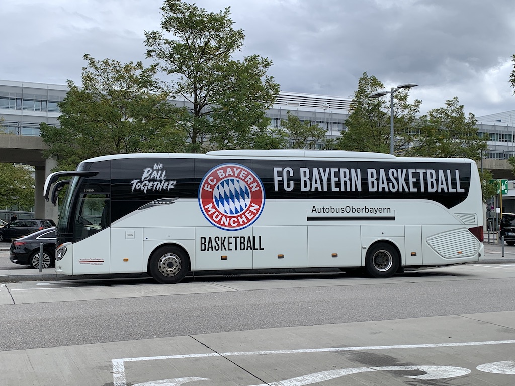 a white bus parked in a parking lot