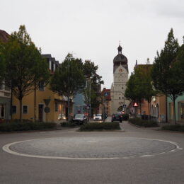 a street with trees and buildings on the side