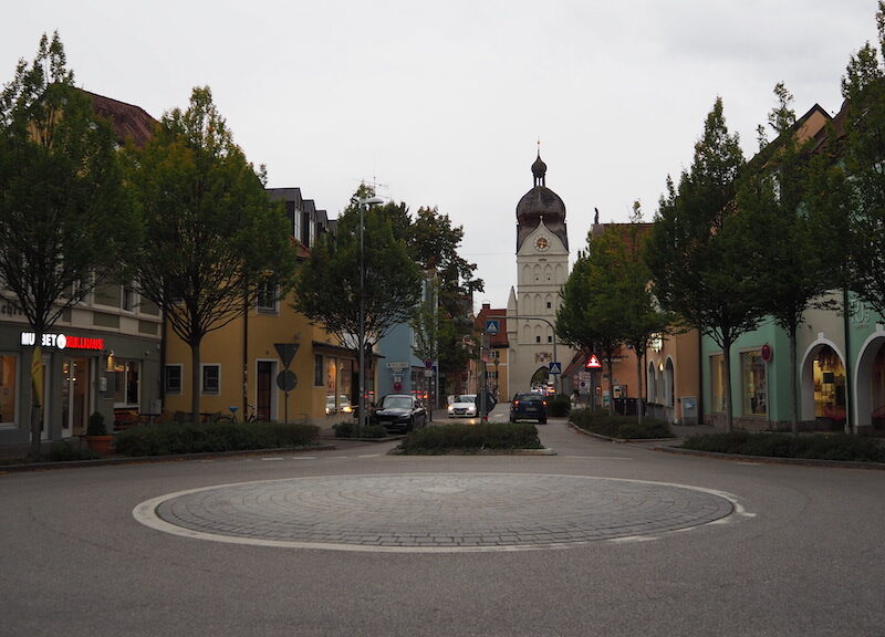 a street with trees and buildings on the side