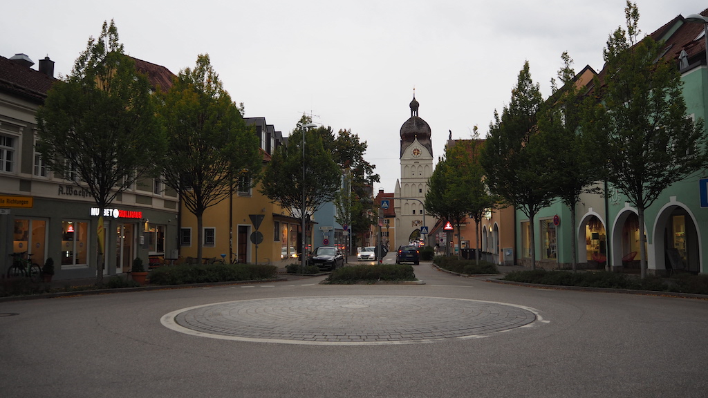 a street with trees and buildings on the side