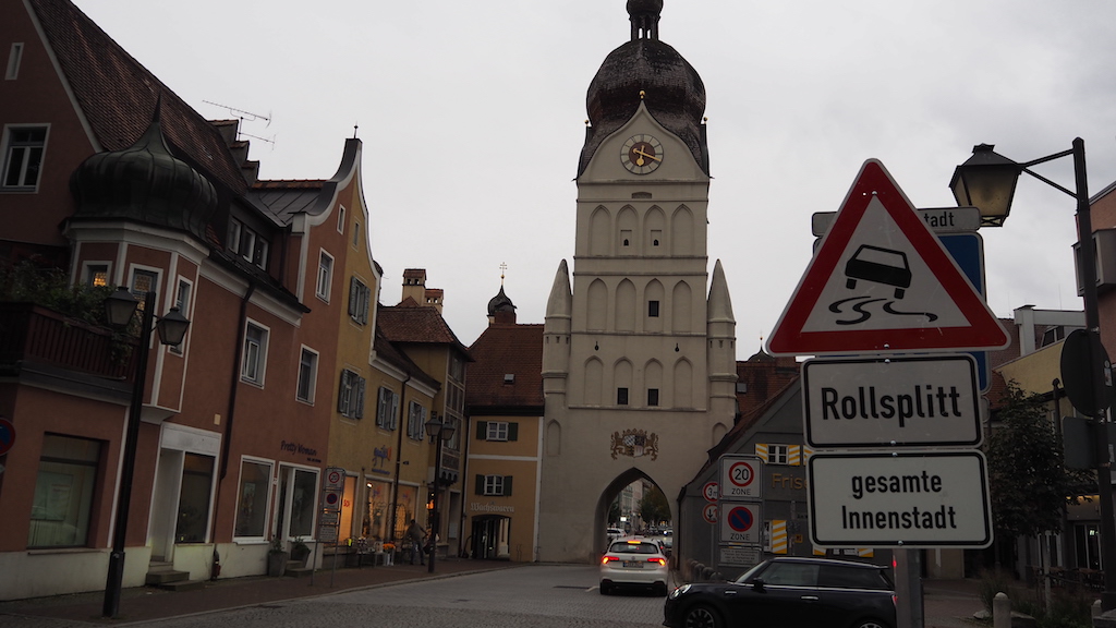 a street sign in front of a large building