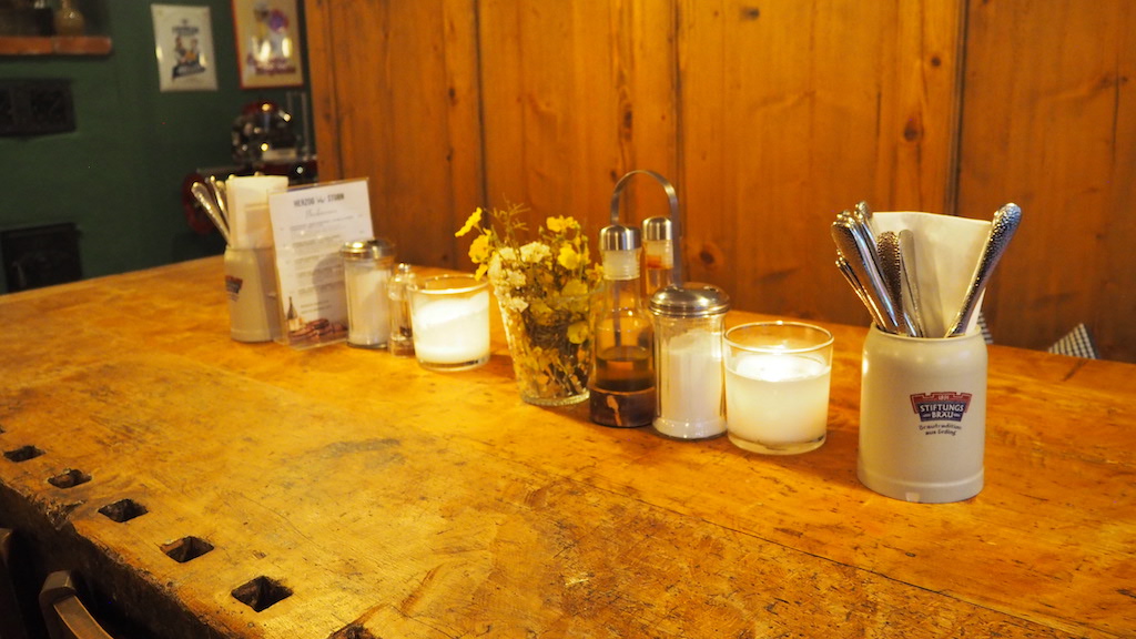 a counter with many candles and flowers on it