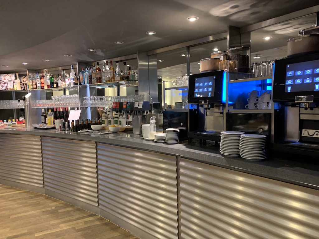 a large kitchen with a counter and many plates on it