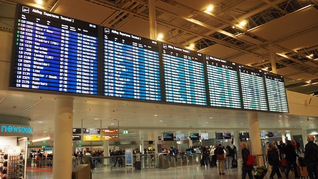 a group of people in a large building with large screens